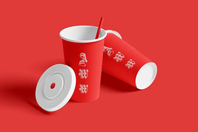 Two red paper drink cups with a straw and separate white lid on a red background