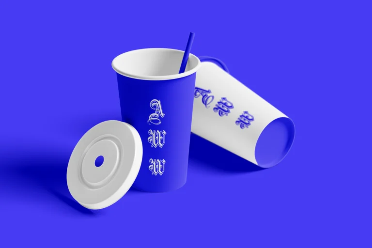 Blue and white paper drink cups with a straw and separate white lid on a blue background