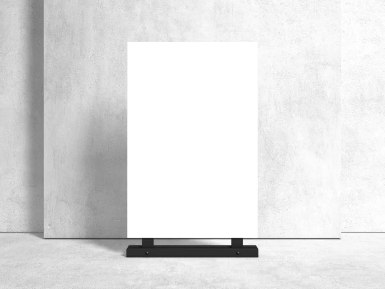 Blank 24x36 advertising stand poster mockup against a textured white wall