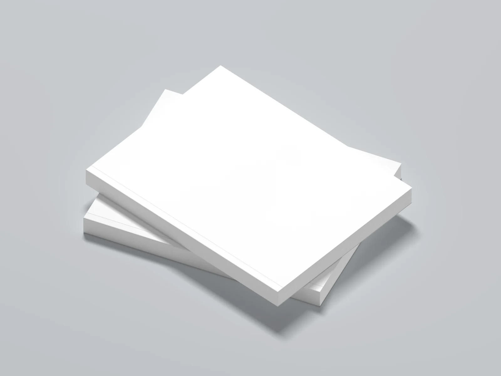Blank white softcover books stacked at an angle on a light gray background