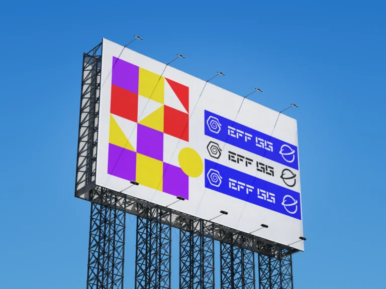 Outdoor billboard mockup viewed from the left against a clear blue sky