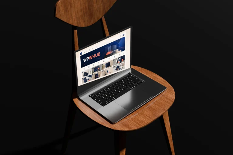 Laptop on a wooden chair displaying a colorful Wpwhub website design