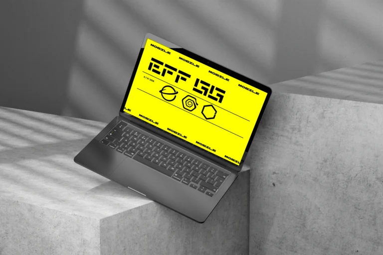 Laptop screen mockup with yellow interface displayed on concrete blocks