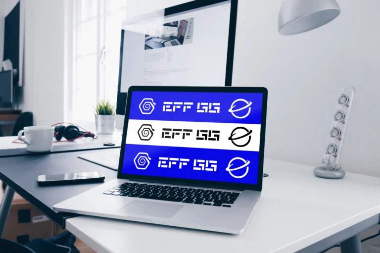 MacBook home desk mockup displaying a blue website design