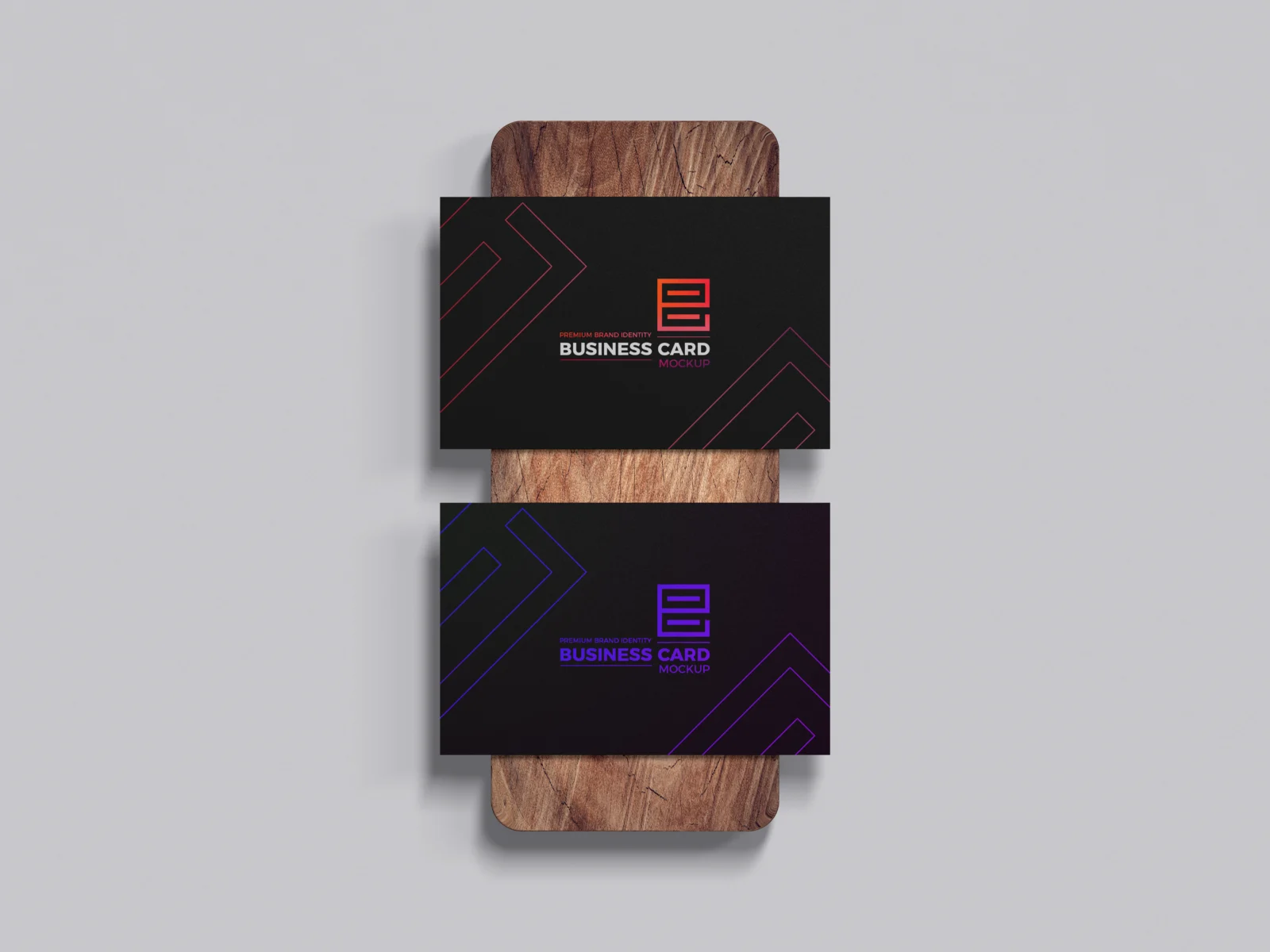 Two black brand identity business card mockups displayed on a wooden surface