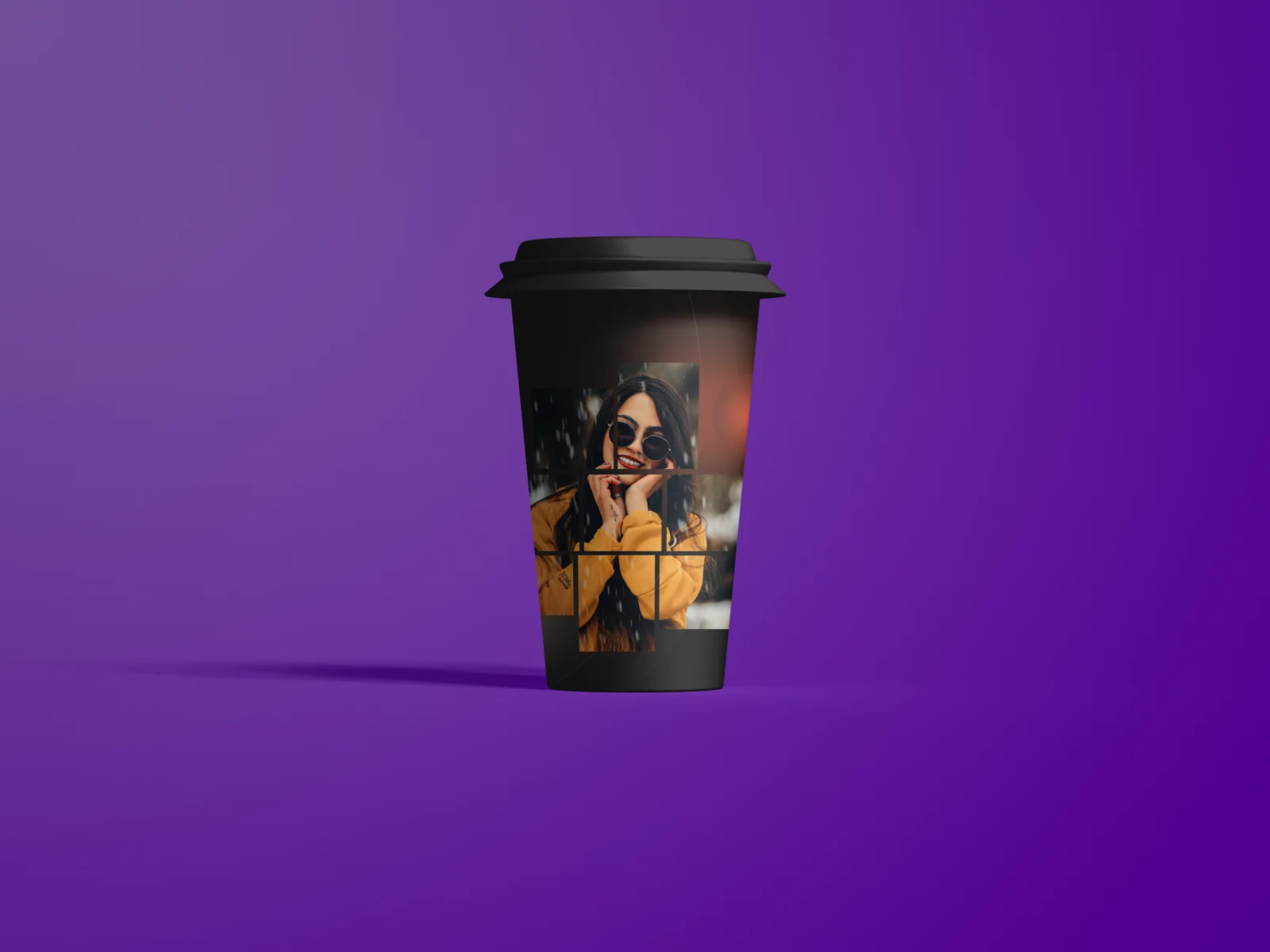 Black takeaway coffee cup mockup with a photo design on a purple background